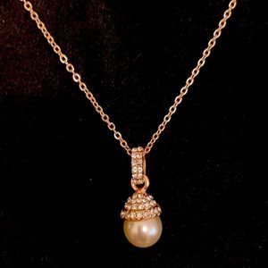 5/$25 faux necklace with pendant: gold colored with pearl and diamonds.
